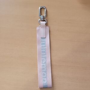 Lululemon Never Lost Keychain in a pink/silver